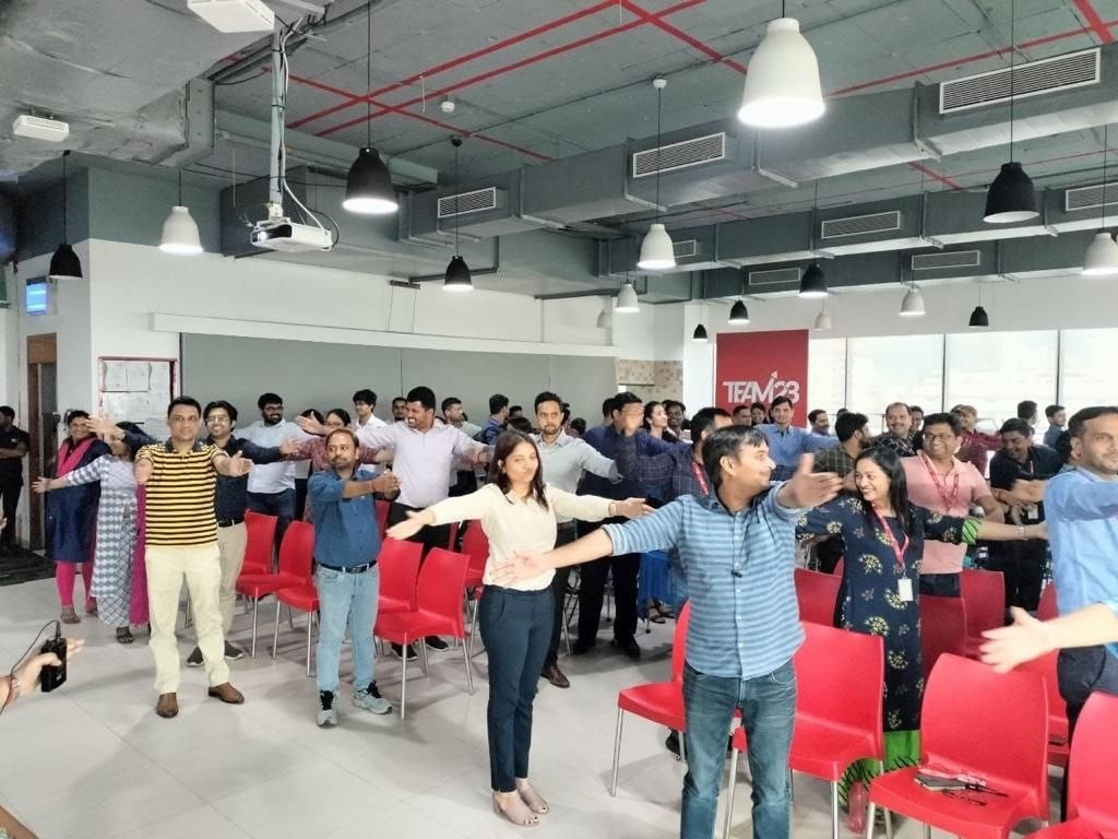 Team doing arm stretches at D-Physio corporate workshop